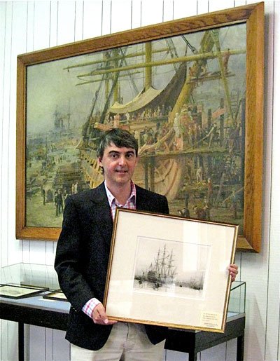 A maritime etching framed in the gallery, before a large Wyllie shipyard oil.